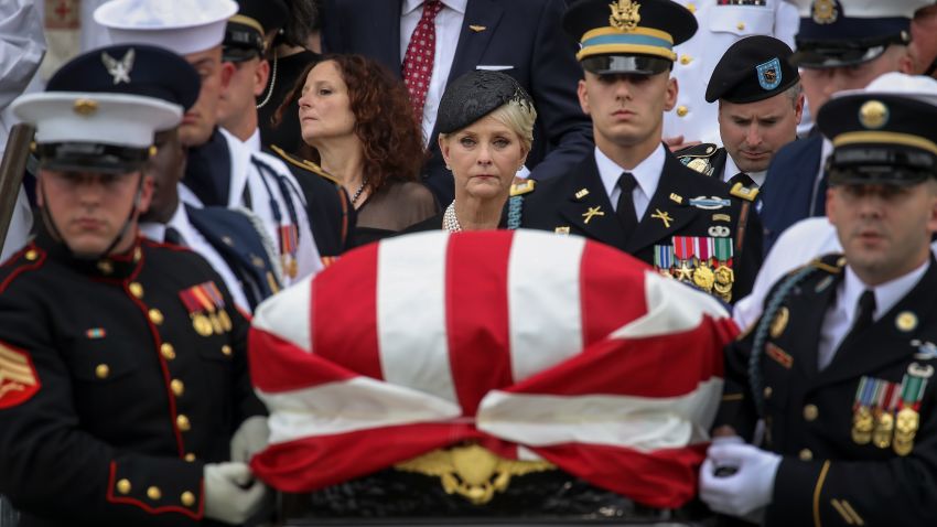 WASHINGTON, DC - SEPTEMBER 1: Cindy McCain looks on as a joint military service casket team carries the casket of the late Senator John McCain following his funeral service at the Washington National Cathedral, September 1, 2018 in Washington, DC. Former presidents Barack Obama and George W. Bush delivered eulogies for McCain in front of the 2,500 invited guests. McCain will be buried on Sunday at the U.S. Naval Academy Cemetery. (Photo by Drew Angerer/Getty Images)