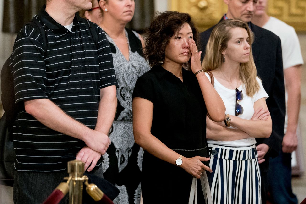 A visitor becomes emotional while paying respects to the late senator as he lied in state Friday in the US Capitol's rotunda.