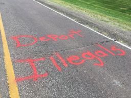The spray-painted message appeared on the road Thursday.