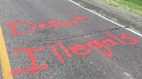 The spray-painted message appeared on the road Thursday.