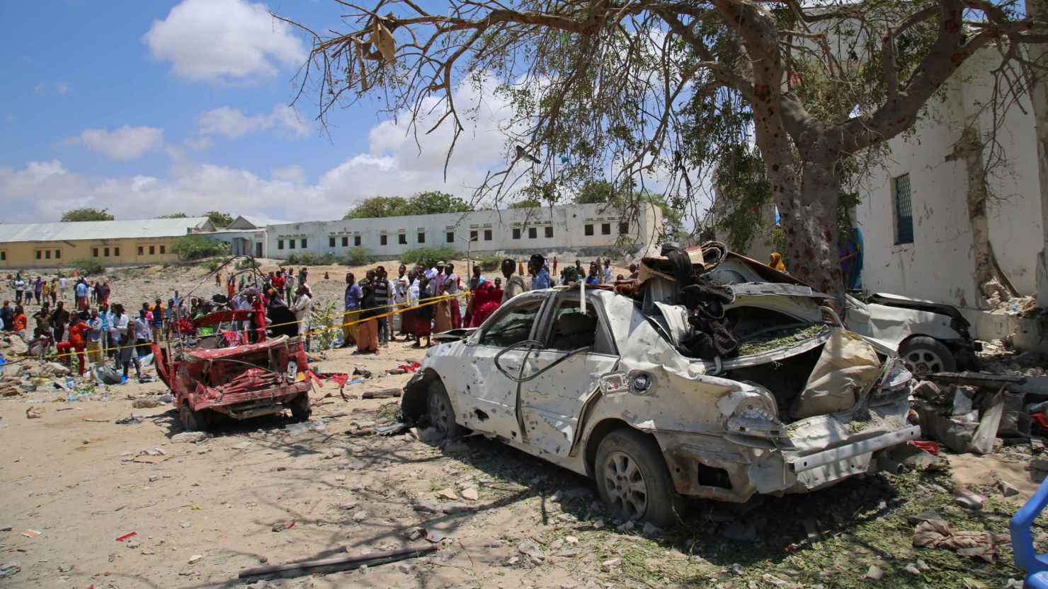 People inspect damage around the site after an attack carried out with a bomb-laden vehicle on September 02, 2018, in Mogadishu, Somalia.