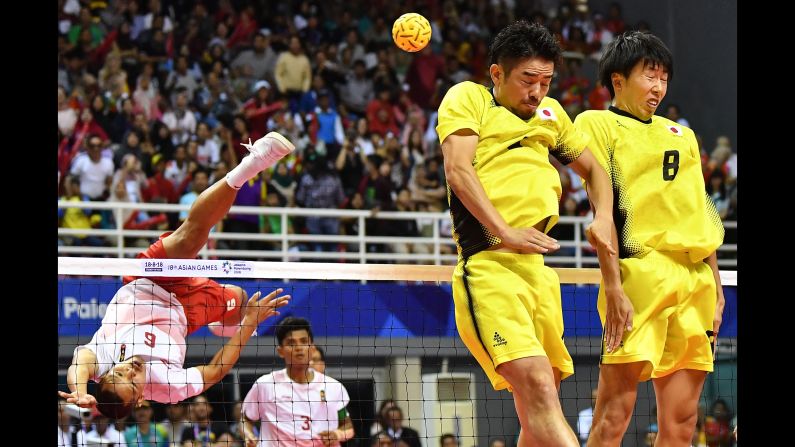 Japan's Takeshi Terashima, second left, and Hirokazu Kobayashi, right, defend against Indonesia's Nofrizal in the sepak takraw (kick volleyball) men's quadrant final on Saturday, September 1.