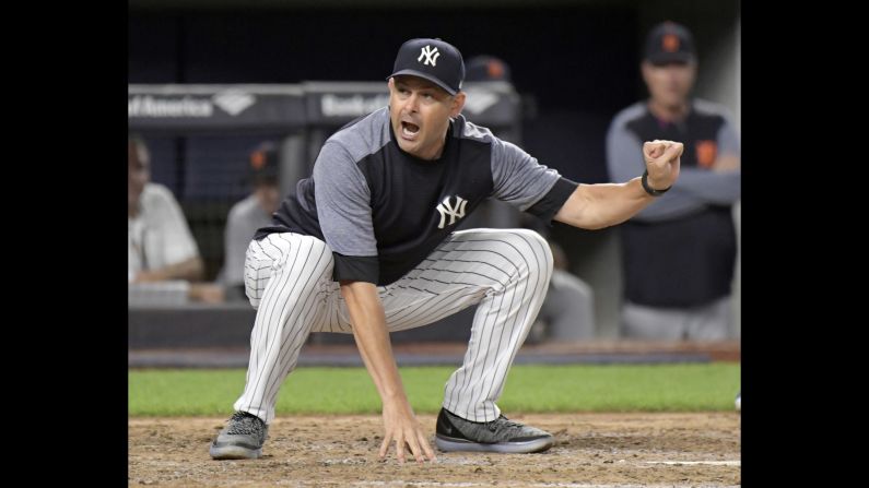 New York Yankees manager Aaron Boone argues with home plate umpire Nic Lentz before being tossed from the game against the Detroit Tigers during the fifth inning on Friday, August 31.