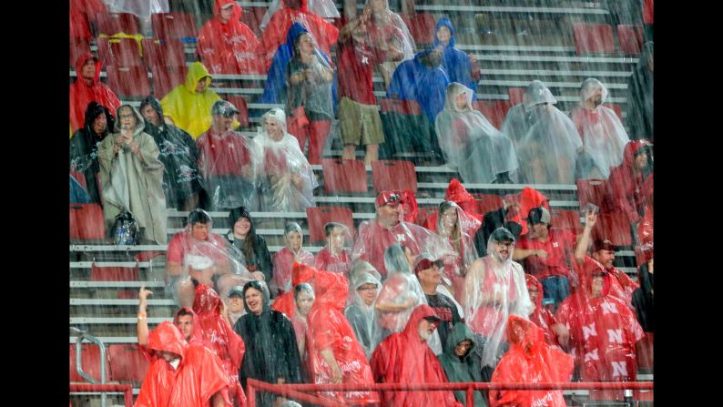 Fans at Memorial Stadium in Lincoln, Nebraska, brave the elements during a lightning and rain delay in the first half of the football game between Nebraska and Akron on Saturday, September 1. The game was eventually canceled.