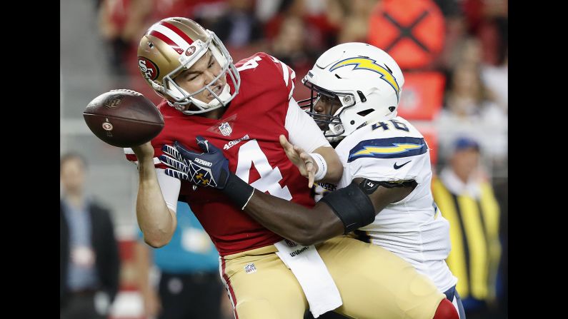 San Francisco 49ers quarterback Nick Mullens fumbles as he is sacked by Los Angeles Chargers defensive end Chris Landrum during the first half of an NFL preseason football game on Thursday, August 30.