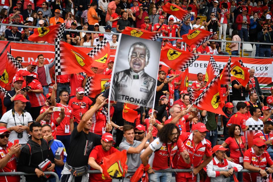 Ferrari's sea of fans -- the 'Tifosi' -- hold up a flag making fun of Lewis Hamilton, but he has the last laugh, winning the Italian Grand Prix for the fifth time