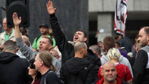  A man raises his arm in a Heil Hitler salute towards heckling leftists at a right-wing protest  in Chemnitz.
