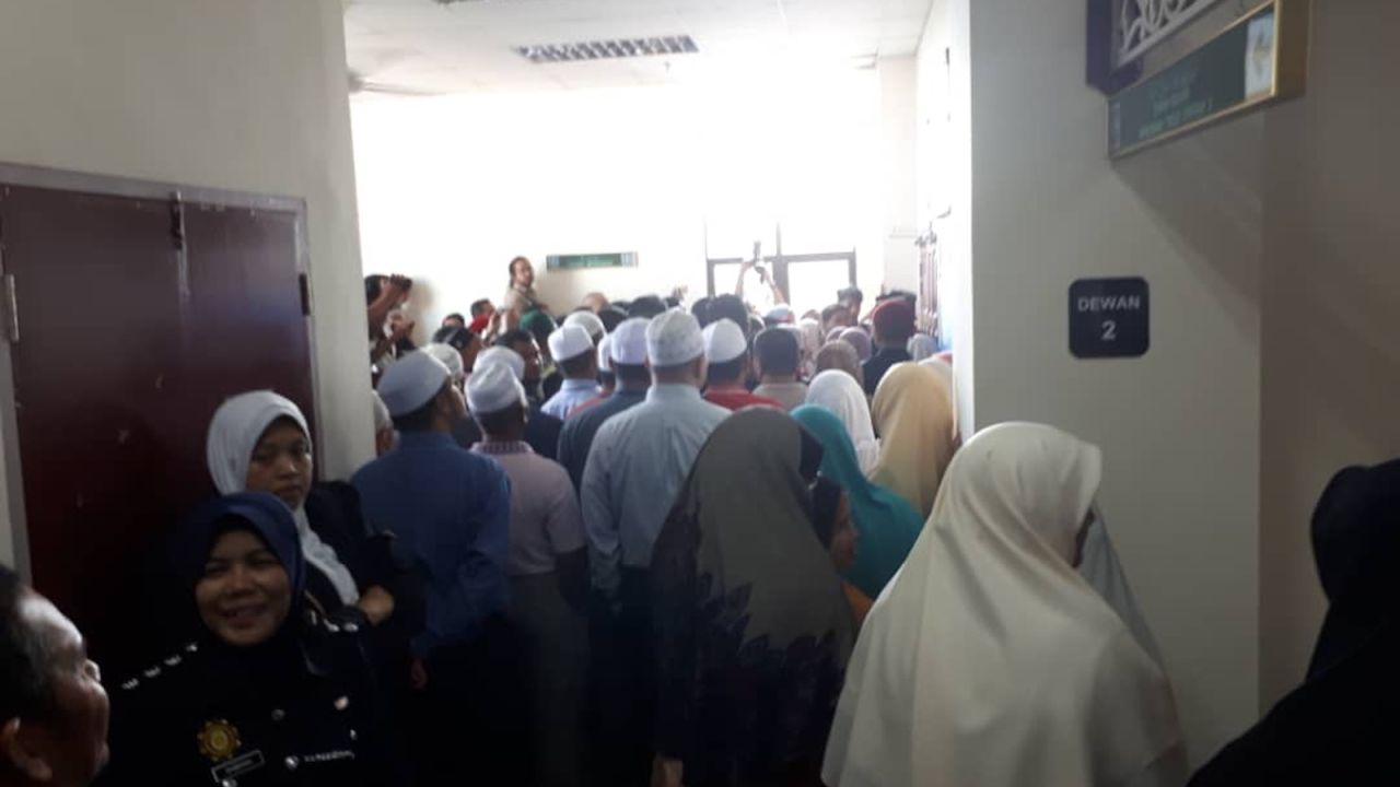 Observers gather to witness the caning of two women convicted of having sex in Terengganu, Malaysia, in 2018.
