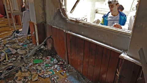 A young Libyan man inspects the interior of a mosque in Benghazi on February 9, 2018, after it was hit in a twin bomb attack.