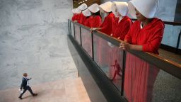 WASHINGTON, DC - SEPTEMBER 04:  Protesters dressed in The Handmaid's Tale costume, protest outside the hearing room where Supreme Court nominee Judge Brett Kavanaugh will testify before the Senate Judiciary Committee during his Supreme Court confirmation hearing in the Hart Senate Office Building on Capitol Hill September 4, 2018 in Washington, DC. Kavanaugh was nominated by President Donald Trump to fill the vacancy on the court left by retiring Associate Justice Anthony Kennedy.
(Photo by Win McNamee/Getty Images)