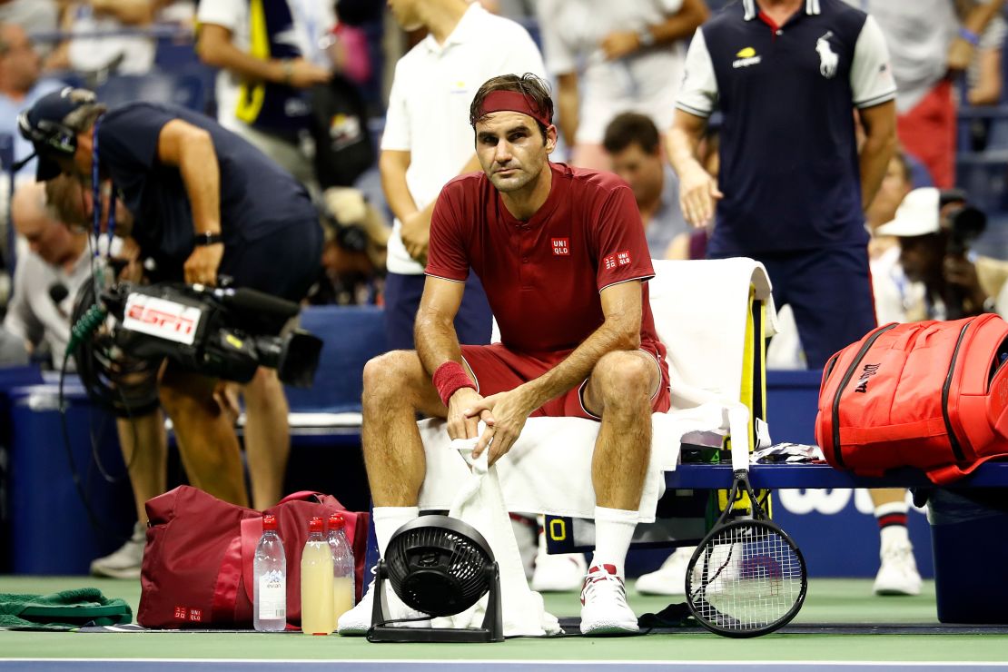 Federer sits on the baseline following defeat.