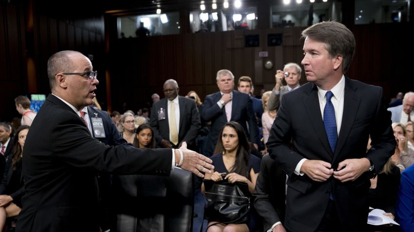 Fred Guttenberg, the father of Jamie Guttenberg who was killed in the Stoneman Douglas High School shooting in Parkland, Fla., left, attempts to shake hands with President Donald Trump's Supreme Court nominee, Brett Kavanaugh, right, as he leaves for a lunch break while appearing before the Senate Judiciary Committee on Capitol Hill in Washington, Tuesday, Sept. 4, 2018, to begin his confirmation to replace retired Justice Anthony Kennedy.