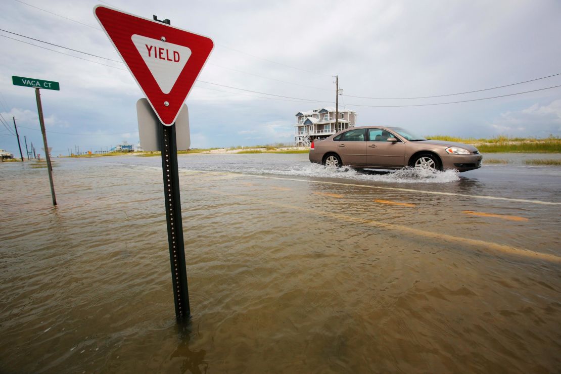 A car drives on a flooded road as Tropical Storm Gordon approached on Tuesday, September 4, 2018, in Dauphin Island, Alabama.