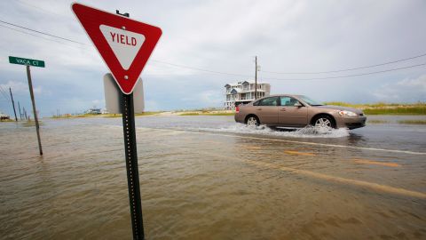 A car drives on a flooded road as Tropical Storm Gordon approached on Tuesday, September 4, 2018, in Dauphin Island, Alabama.