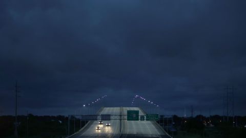 Vehicles pass over a US Route 90 bridge as Tropical Storm Gordon darkened the skies in Pascagoula, Mississippi, on September 4.