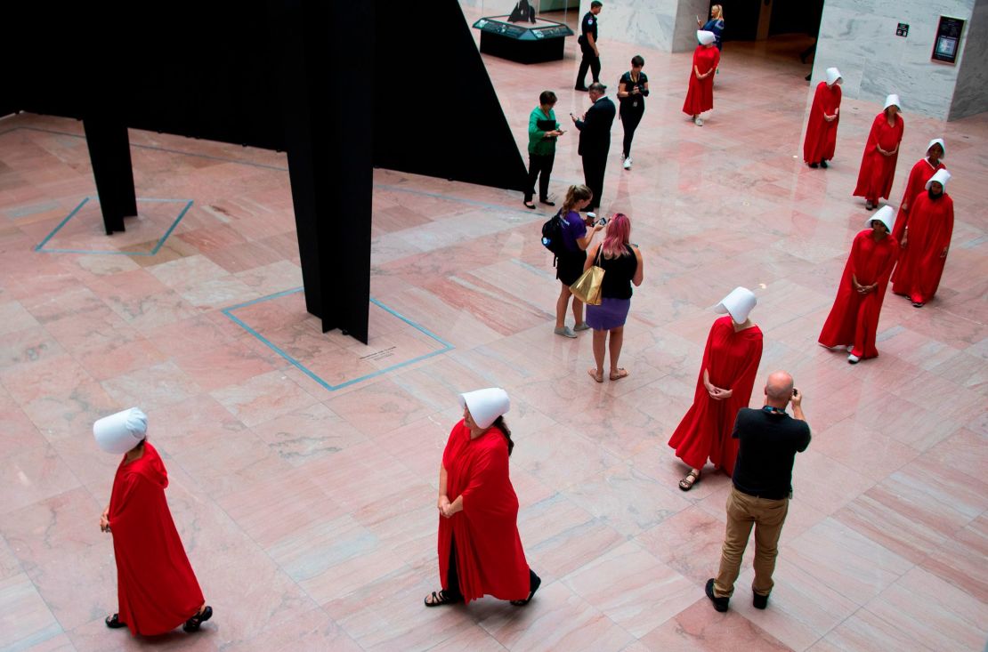 Women dressed as characters from the novel-turned-TV series "The Handmaid's Tale" walk through the Hart Senate Office Building as Supreme Court nominee Brett Kavanaugh starts the first day of his confirmation hearing.