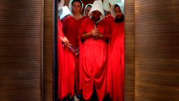 Women dressed as characters from "The Handmaid's Tale" stand in an elevator at the Hart Senate Office Building  as Supreme Court nominee Brett Kavanaugh starts the first day of his confirmation hearing.