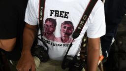 A journalist, wearing a T-shirt urging to free detained Myanmar journalists Wa Lone and Kyaw Soe Oo, waits at a court in Yangon on August 27, 2018. - A Myanmar court on August 27 postponed ruling on whether two Reuters journalists violated a state secrets law while reporting on the Rohingya crisis, with a new date set for next week. (Photo by Ye Aung THU / AFP)        (Photo credit should read YE AUNG THU/AFP/Getty Images)