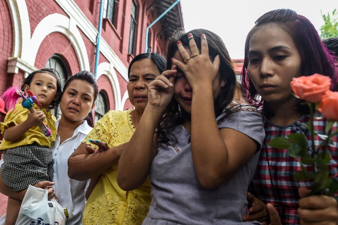 Chit Su Win, second right, the wife of jailed Myanmar journalist Kyaw Soe Oo grieves with family members outside the court on September 3, 2018. 