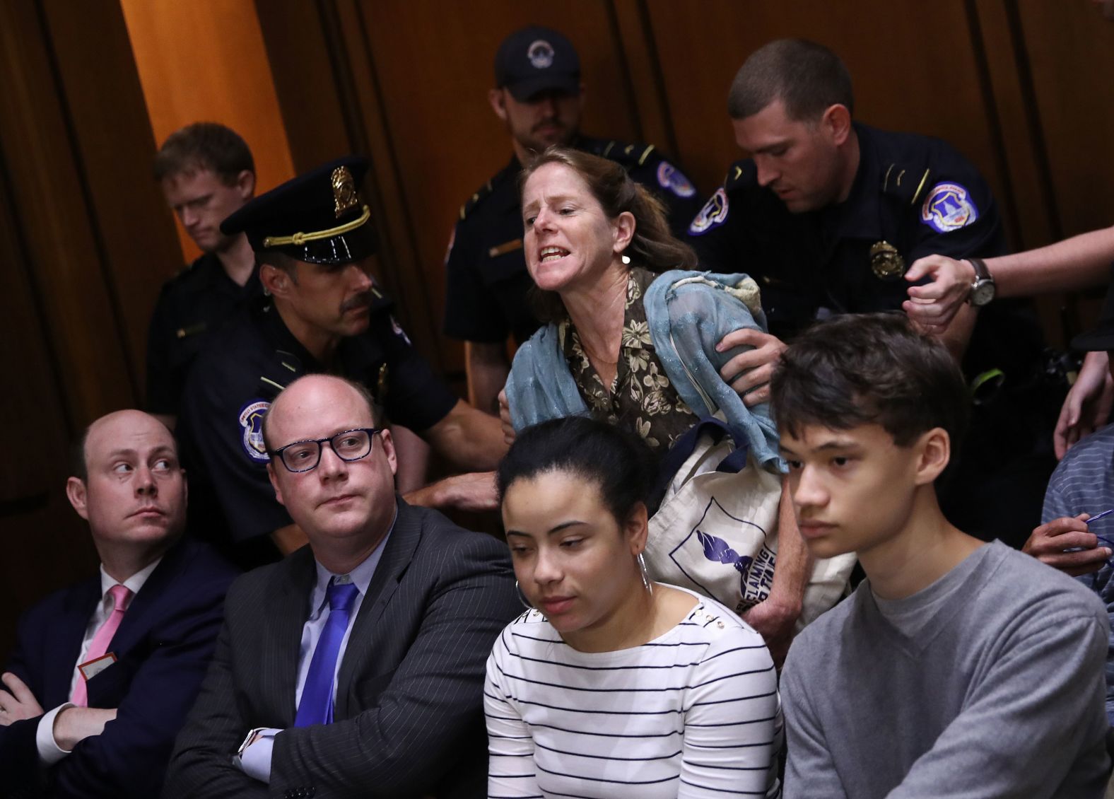 Police remove a protester disrupting the hearing on Wednesday. Capitol Police said <a href="index.php?page=&url=https%3A%2F%2Fwww.cnn.com%2F2018%2F09%2F04%2Fpolitics%2Fcapitol-hill-police-protest-arrests%2Findex.html" target="_blank">they arrested 70 people</a> on Tuesday.