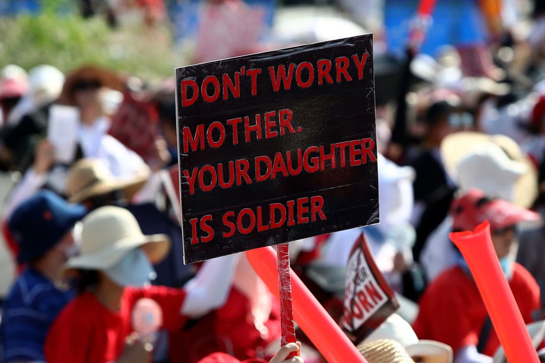A protester holds up a sign at a demonstration in central Seoul on August 4. More protests are expected this month. 