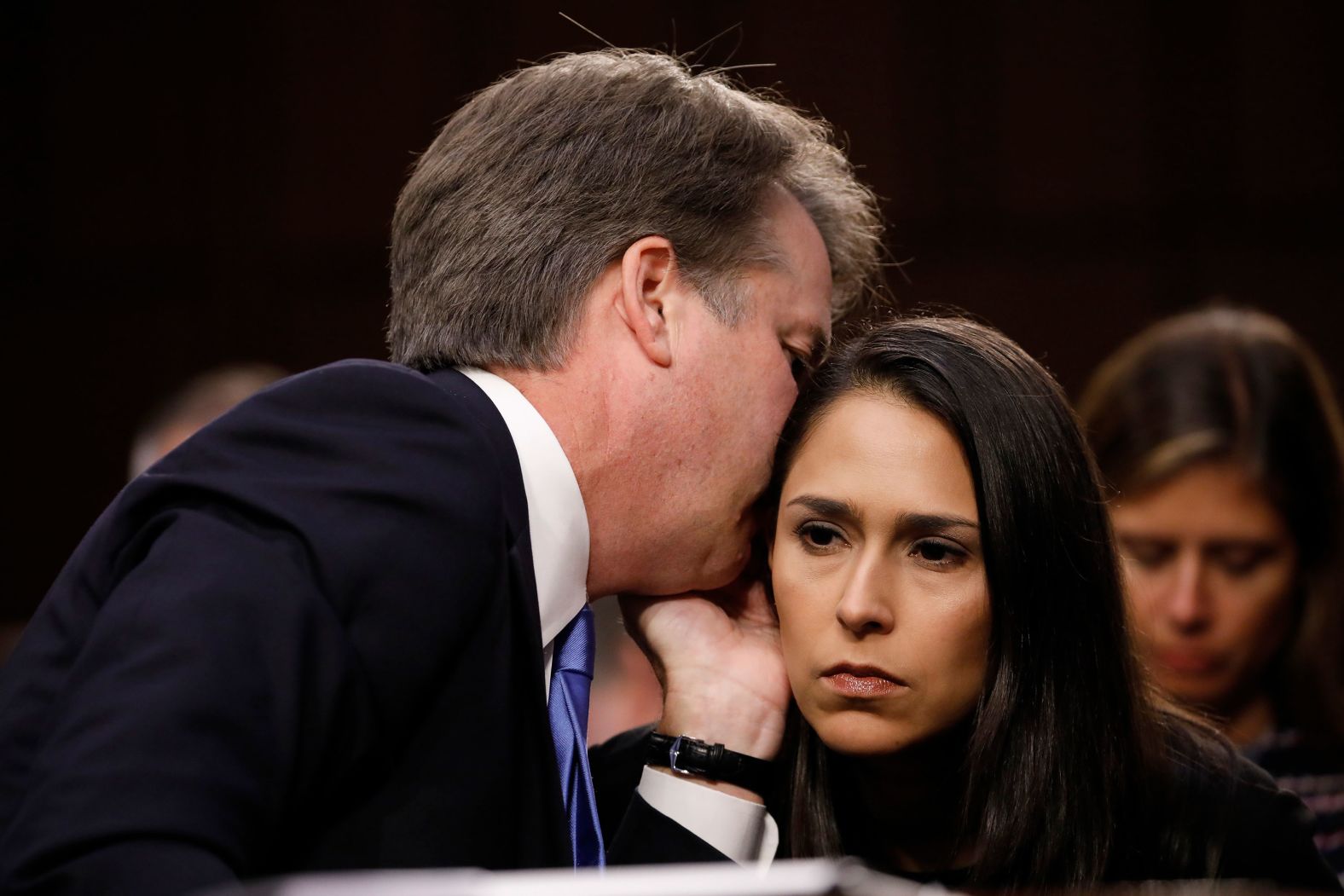 Kavanaugh whispers something Wednesday to Zina Bash, former White House special assistant for regulatory reform, legal and immigration policy.