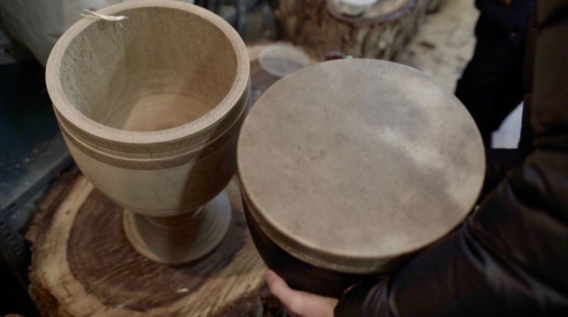 Once the drum's wooden shell is complete, a finely-cured piece of camel or goat skin is glued to the top.