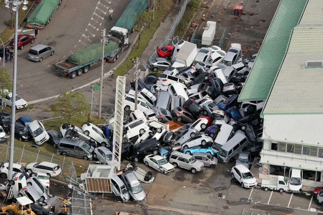 Strong winds in Kobe left cars piled in a heap.