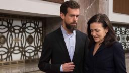 CEO of Twitter Jack Dorsey and Facebook COO Sheryl Sandberg (R) arrive to testify before the Senate Intelligence Committee on Capitol Hill in Washington, DC, on September 5, 2018. (Photo by Jim WATSON / AFP)        (Photo credit should read JIM WATSON/AFP/Getty Images)