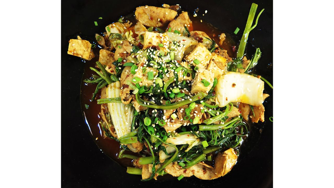 <strong>First Grade Spicy Hot Pot: </strong>Other dishes include this<strong> </strong>fantastic pile of sliced chicken, Chinese cabbage, tofu and morning glory, all drenched in an addictive sauce that zings with a quasi-bacon flavor, and is topped with sesame seeds.<br />
