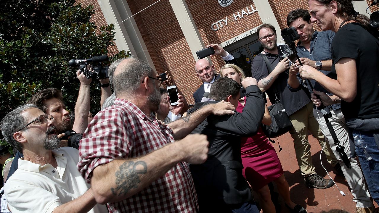 CHARLOTTESVILLE, VA - AUGUST 13:  A counter protester tries to punch Jason Kessler, an organizer of "Unite the Right" rally, after Kessler tried to speak outside the Charlottesville City Hall on August 13, 2017 in Charlottesville, Virginia. The city of Charlottesville remains on edge following violence at a 'Unite the Right' rally held by white nationalists, neo-Nazis and members of the 'alt-right'  (Photo by Win McNamee/Getty Images)
