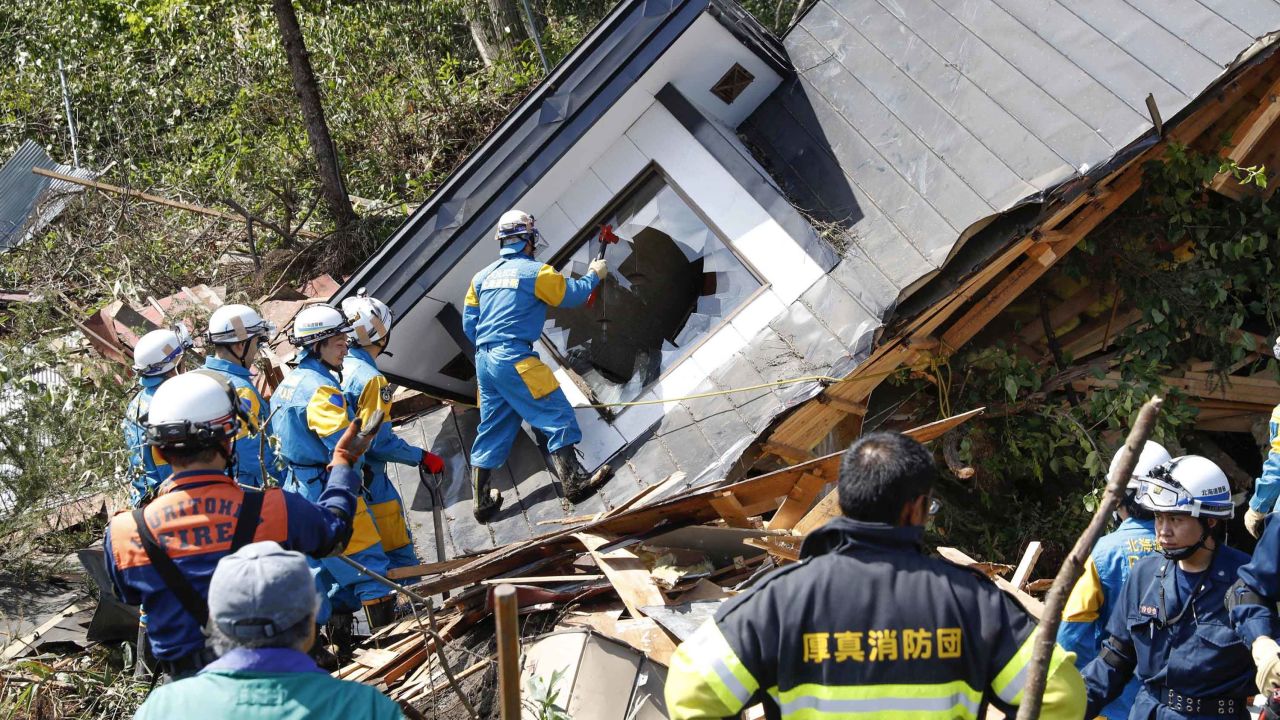 Police search for missing persons around a house destroyed by a landslide after a powerful earthquake in Atsuma, Hokkaido, northern Japan.