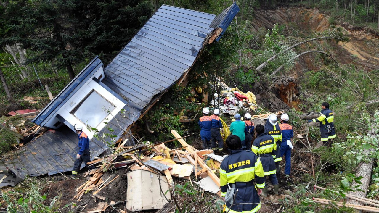 A rescue operation is conducted at a house destroyed by a landslide after a powerful earthquake on September 6, 2018 in Atsuma, Hokkaido, Japan.