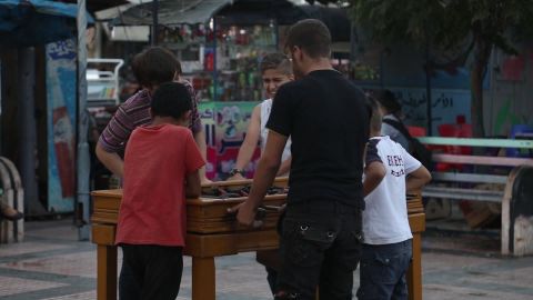 Boys play foosball on the sidewalk of Idlib.