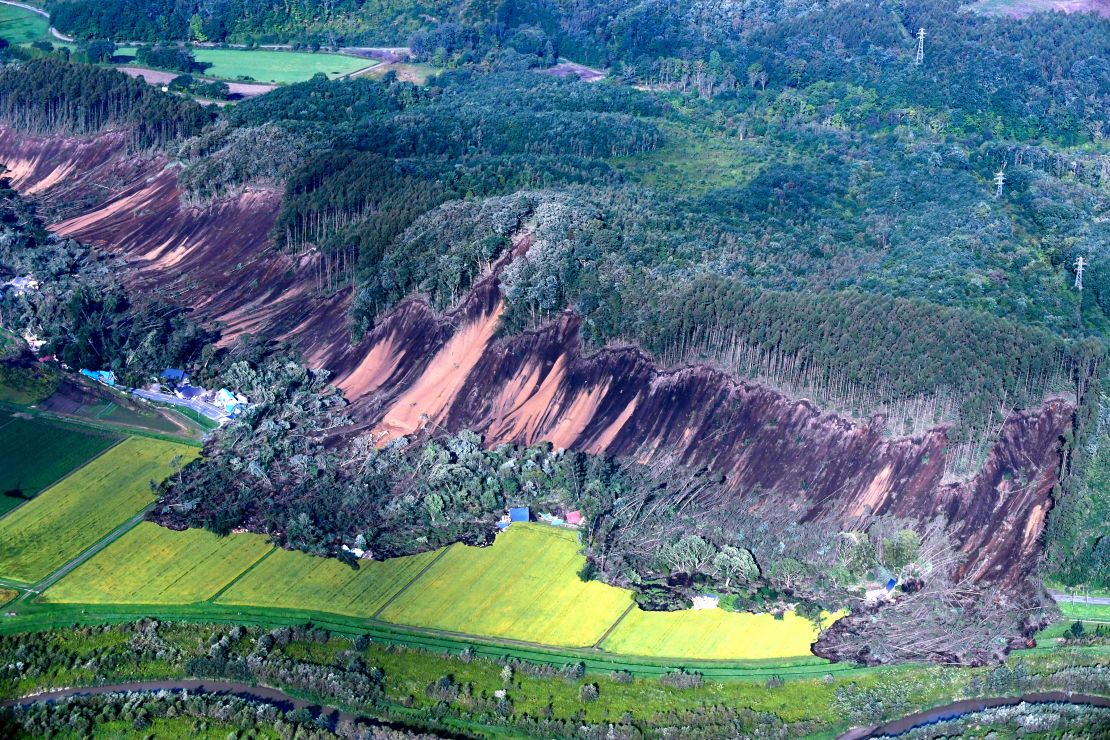 In this aerial image, houses are buried by multiple landslides after a powerful earthquake jolt on September 6, 2018 in Atsuma, Hokkaido, Japan.