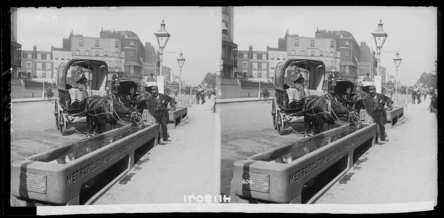 Cab and cart drivers stop to let their horses drink from a trough near Marble Arch, circa 1890. 