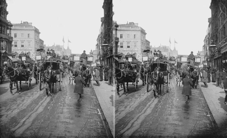 Hansom cabs and public coaches jostle past Oxford Circus, circa 1870. 