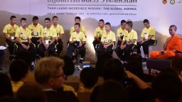 Members of the "Wild Boars" football club and their coach (R) participate in a "meet the press" event at a mall in Bangkok on September 6, 2018. - Twelve boys and their 25-year-old coach of the "Wild Boars" went exploring in Tham Luang cave on June 23 and were trapped deep inside by rising floodwaters, setting off an international search dubbed "Mission Impossible". (Photo by Panumas Sanguanwong / THAI NEWS PIX / AFP)        (Photo credit should read PANUMAS SANGUANWONG/AFP/Getty Images)