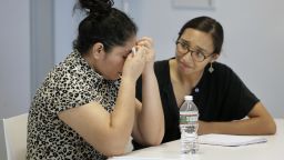 A mother from Guatemala, left, who was separated from her two children after entering the U.S. in May of 2018, receives support from translator Brenda Quintana, right, after speaking to reporters about the separation during a news conference, Thursday, September 6, 2018, in Boston.