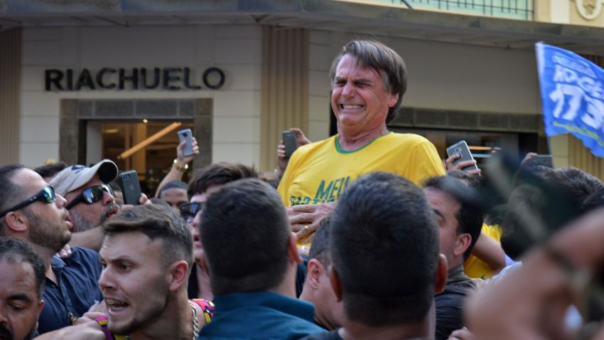 Brazilian right-wing presidential candidate Jair Bolsonaro gestures after being stabbed in the stomach during a campaign rally in Juiz de Fora, Minas Gerais State, in southern Brazil, on September 6, 2018. - Frontrunner Bolsonaro was attacked with a knife while campaigning -- but escaped with just minor injuries, his son said. (Photo by Raysa LEITE / AFP) / RESTRICTED TO EDITORIAL USE - MANDATORY CREDIT "AFP PHOTO /RAYSA LEITE" - NO MARKETING NO ADVERTISING CAMPAIGNS - DISTRIBUTED AS A SERVICE TO CLIENTS        (Photo credit should read RAYSA LEITE/AFP/Getty Images)