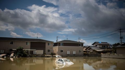 A car sits in water after the area was devastated by flooding and landslides in Mabi, Okayama prefecture on July 10, 2018. 