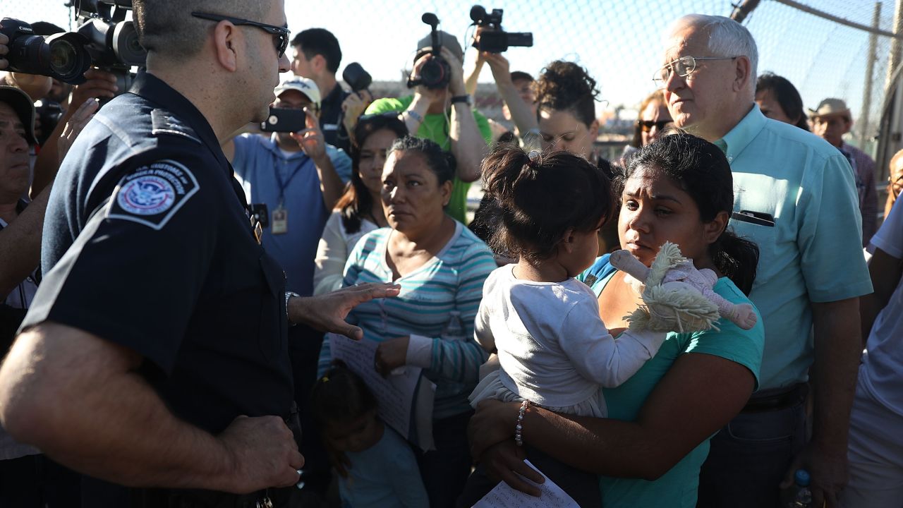 Migrant families seeking asylum encounter Border Patrol agents at the US-Mexico border in June 2018.