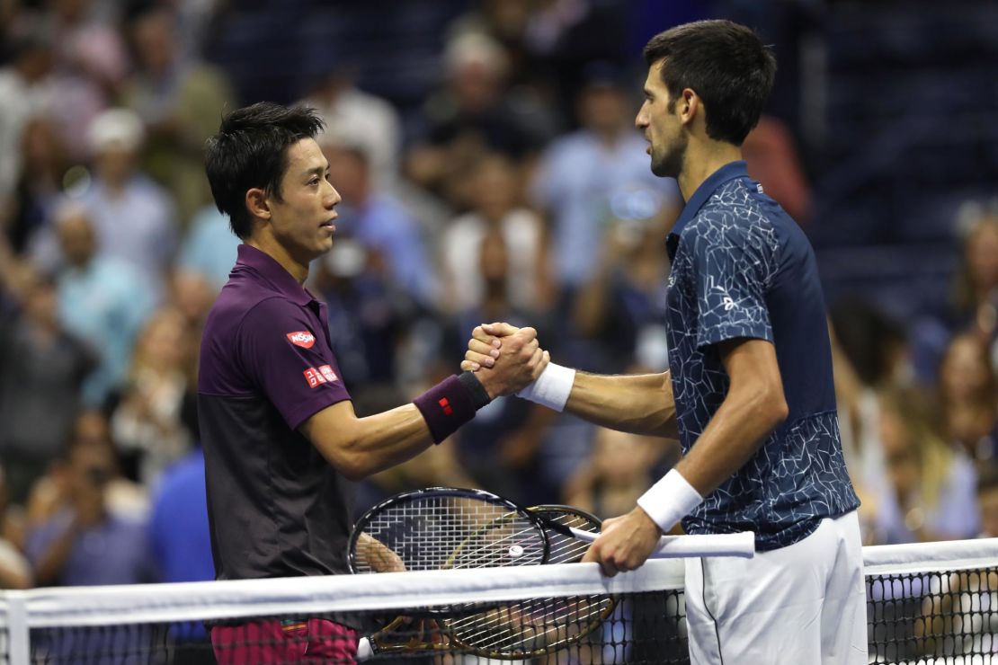 Nishikori and Djokovic shake hands following their men's singles semifinal match.