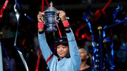 Naomi Osaka, of Japan, holds the trophy after defeating Serena Williams in the women's final of the U.S. Open tennis tournament, Saturday, September 8 in New York.