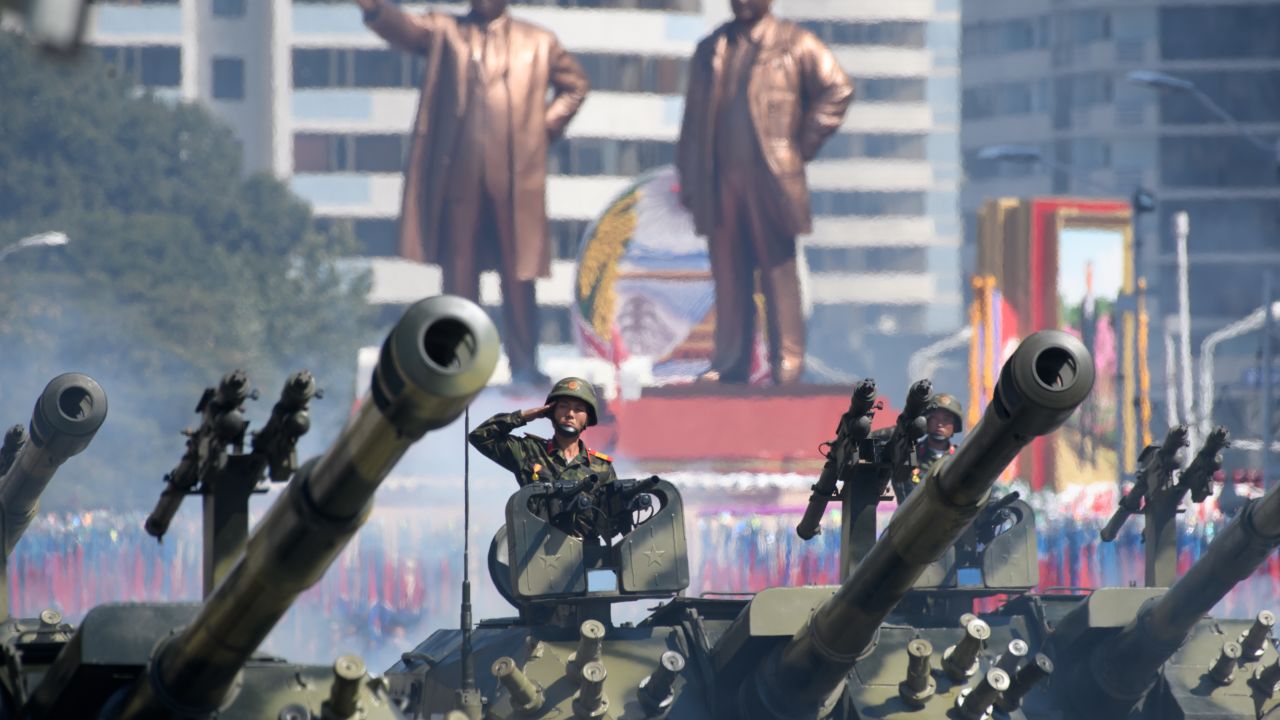 North Korean soldiers salute as they ride tanks during a military parade and mass rally on Kim Il Sung square in Pyongyang on September 9, 2018.
