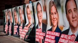 A woman walks next to election posters of (R-L) the leader of the Social Democrats and Swedish Prime Minister Stefan Loefven, Swedish Minister for Finance Magdalena Andersson and Sweden's Foreign Minister Margot Wallstrom on September 1, 2018 in Stockholm.