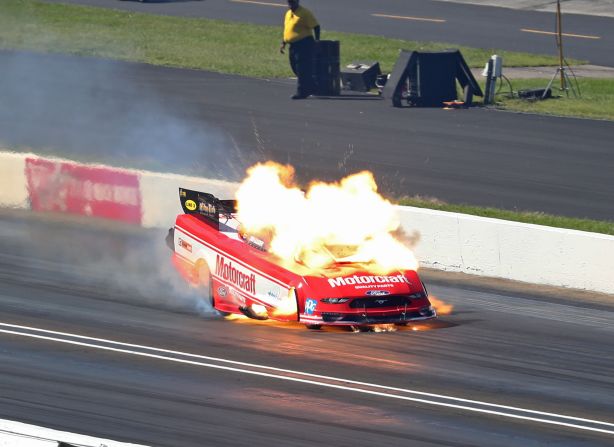An NHRA funny car driven by Bob Tasca III catches fire during the US Nationals at Lucas Oil Raceway on Monday, September 3. Tasca was not injured.