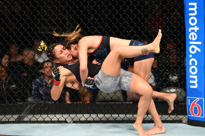 Tatiana Suarez takes down Carla Esparza in their women's strawweight fight during the UFC 228 event at American Airlines Center on Saturday, September 8, in Dallas.