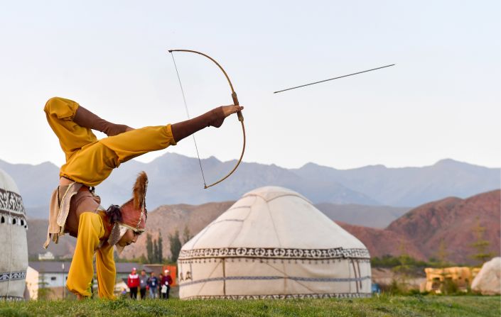 A woman shoots a bow and arrow with her feet at the 2018 World Nomad Games in the town of Cholpon-Ata, Issyk-Kul Region, Kyrgyzstan, on Tuesday, September 4. The event is held every two years and includes 37 sporting events, such as horse riding, national wrestling, martial arts, archery and traditional mind games.