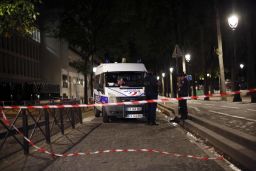 Police officers secure the site of the knife attack Monday in Paris. 